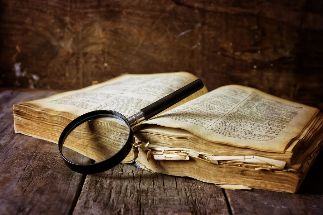 magnifying glass and old book