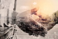 Double exposure of Business partnership meeting concept.photo businessmans handshake. Successful businessmen handshaking after perfect deal.close up,London architecture city