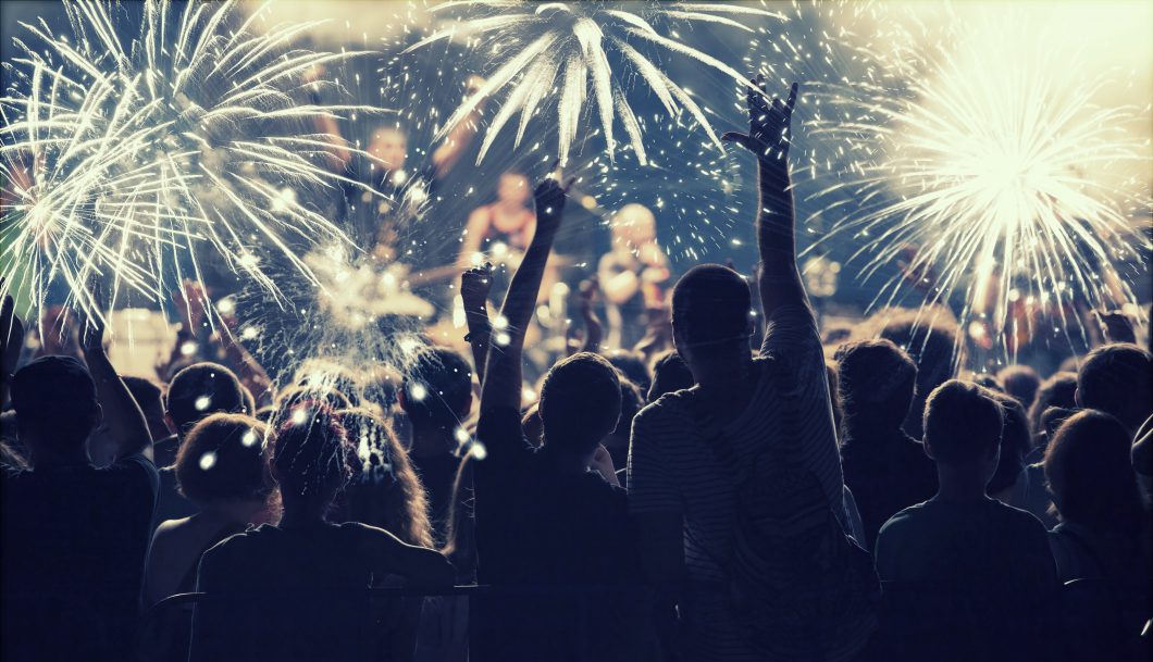 New Year concept – cheering crowd and fireworks