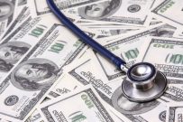 heap of dollars with stethoscope.
