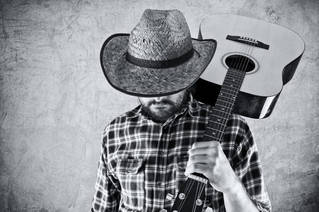 Western country cowboy musician with guitar