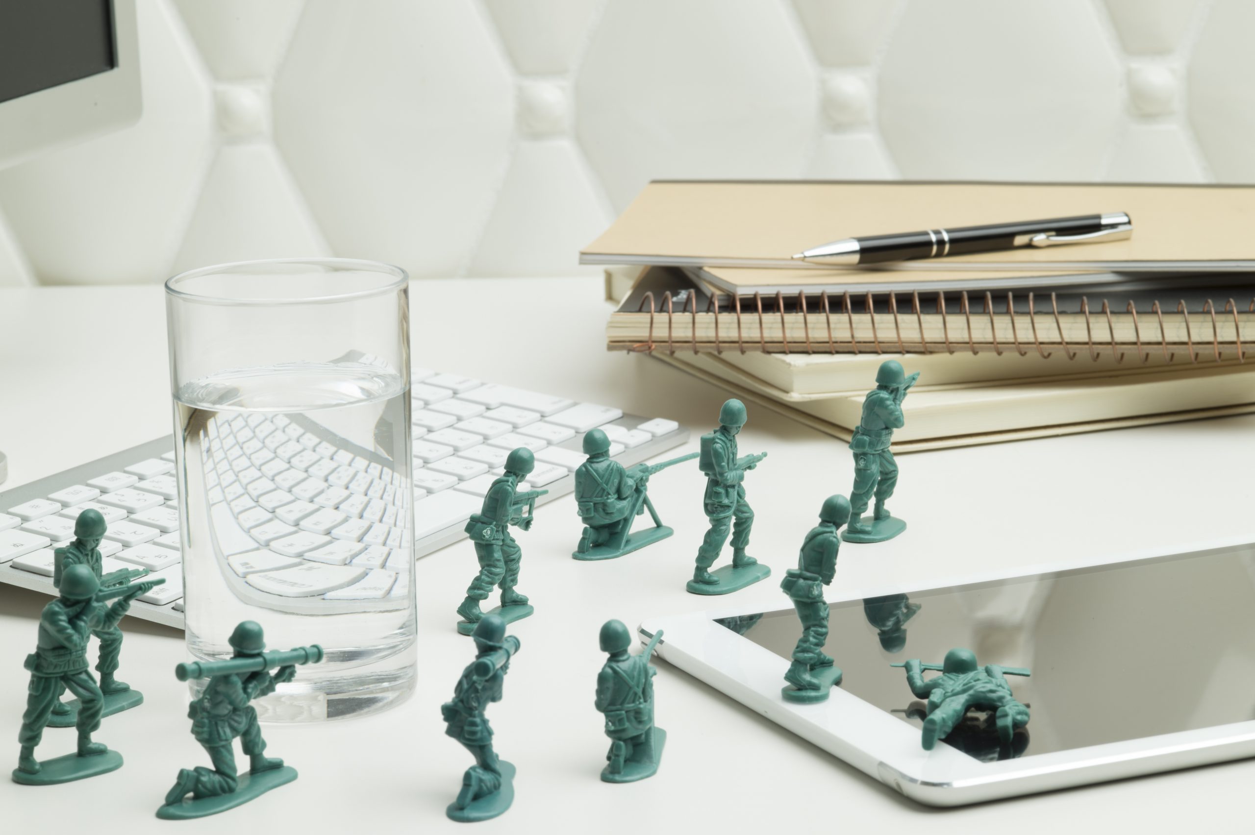 Miniature soldiers are fighting on the desk