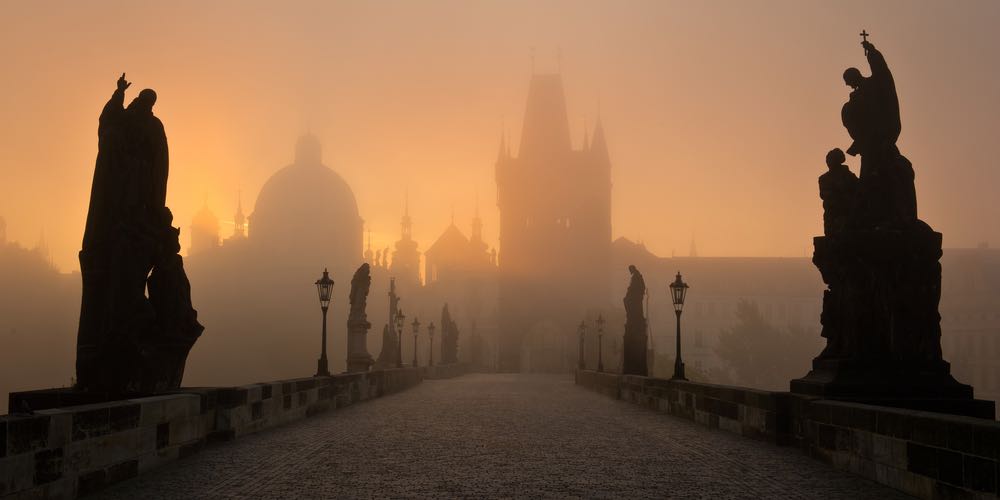Famous Prague Charles bridge in misty morning