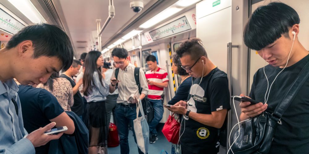 Asian People Staring at Smartphone inside Train in Shenzhen, China – April 2018