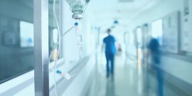 Silhouette of a doctor walking in a hurry in the hospital corridor.