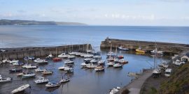 yaughts in a square harbour with a blue sky above