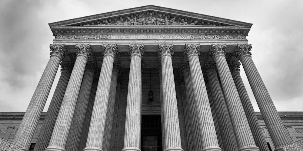 The Supreme Court building in Washington DC. in black and white.