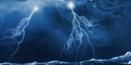 Image of dark night with lightning above stormy sea