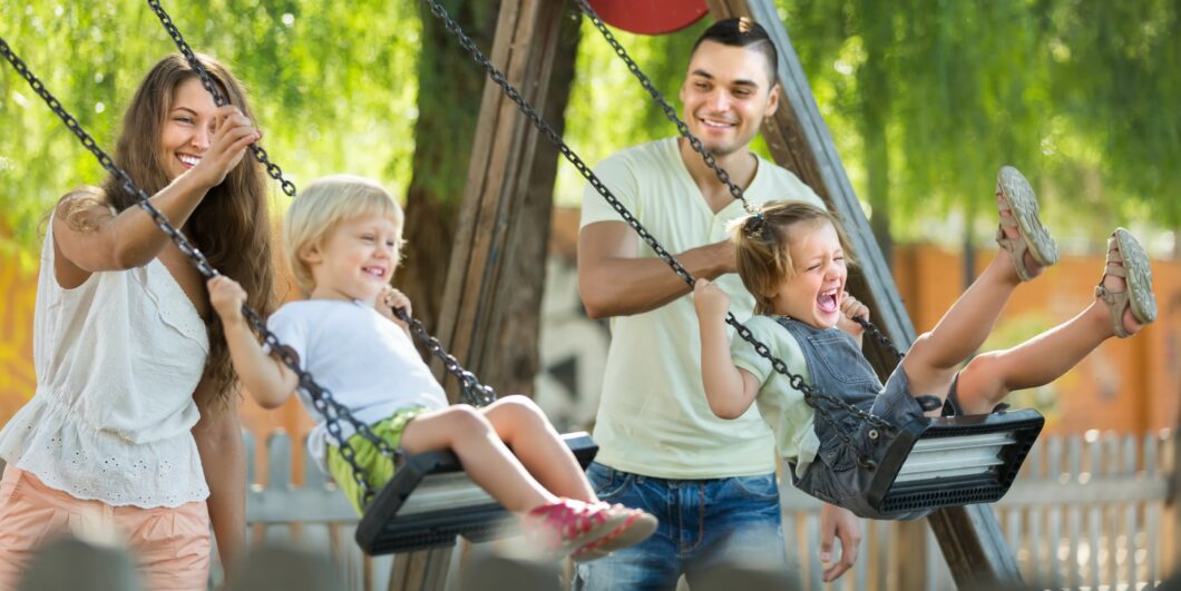 parents w kids on swings_shutterstock_282010403