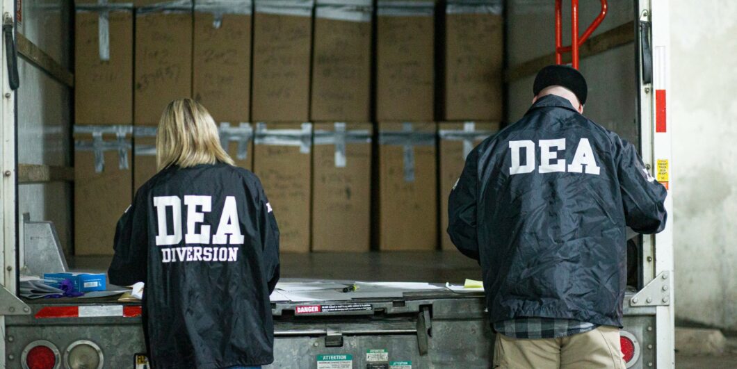 DEA agents standing at back of truck_GettyImages-1232505074