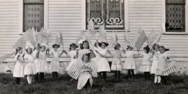 little girls waving USA flags c. 1915_shutterstock_1471900